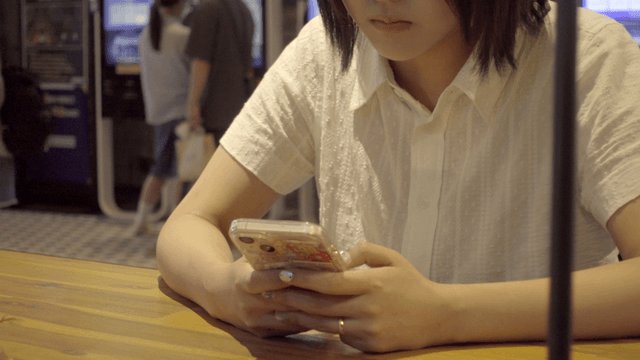 Woman using a smartphone at a cafe