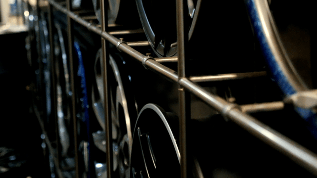 Rims stored on metal shelves in a warehouse