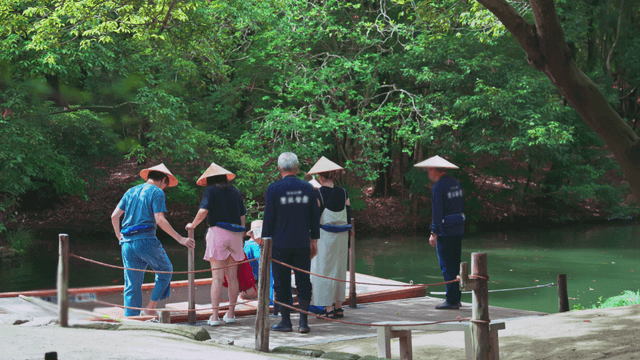 People boarding a boat in a lush forest