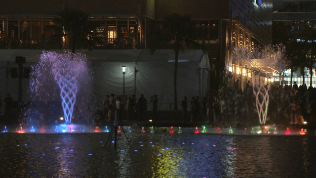 Colorful fountain show at night in the city
