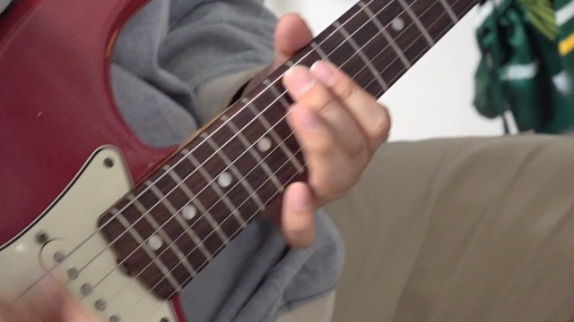 Playing an electric guitar indoors