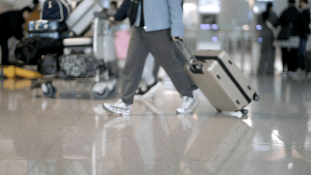 People walking with luggage in an airport