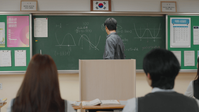 Teacher explaining math in a classroom