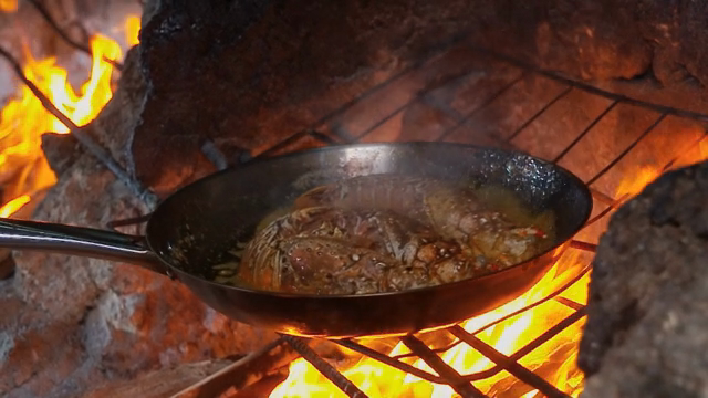Lobster cooking over an open flame