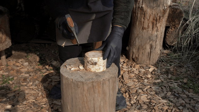 Person chopping wood outdoors