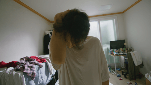 Young man in a cluttered room