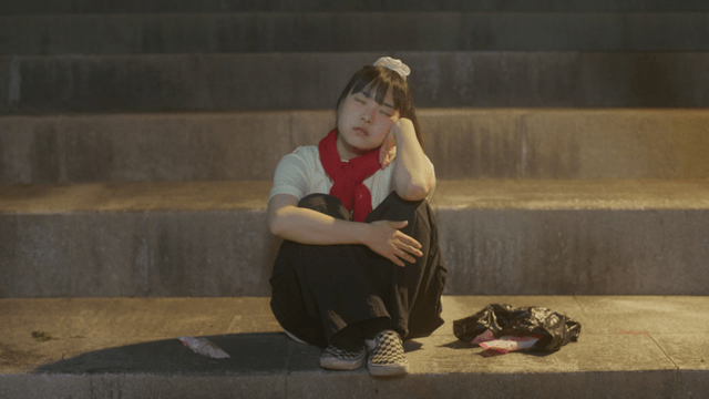 Girl sitting on stairs dropping ice cream