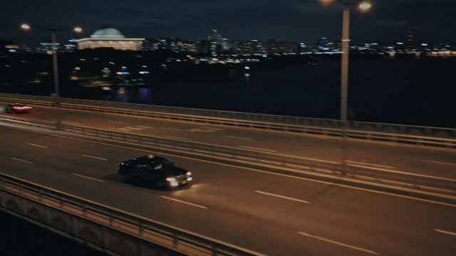 Night view of a bridge with moving cars