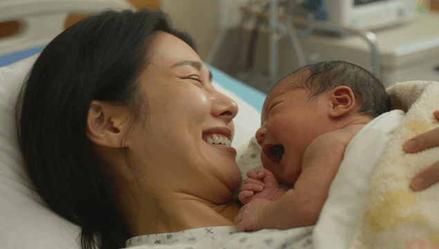 Mother holding a newborn baby in the hospital