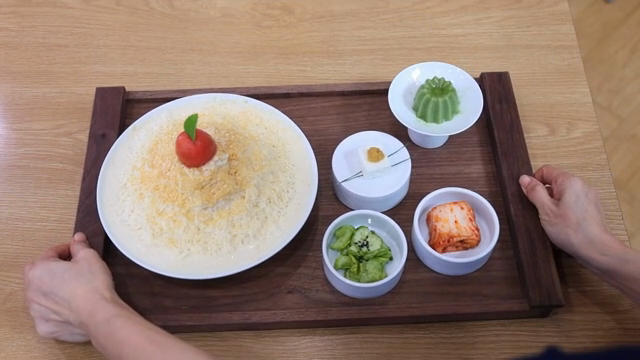 A tray with Korean dishes on a table