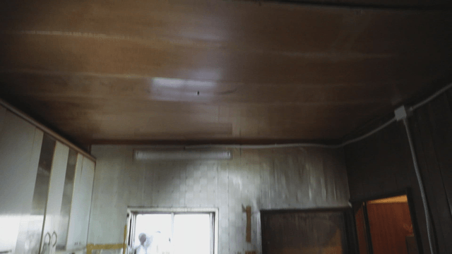 Neglected house kitchen with a wooden ceiling that looks like it could collapse