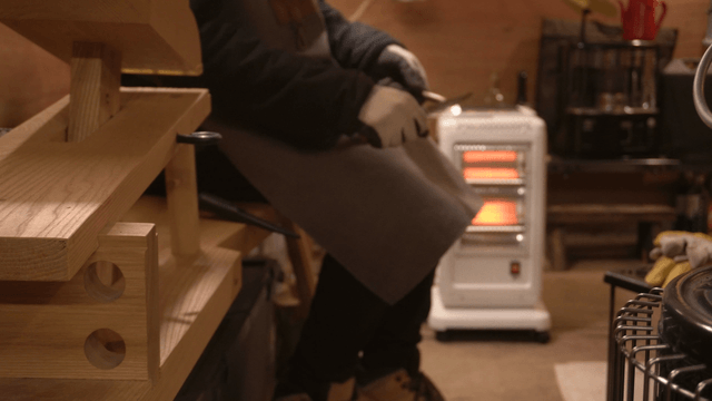 Woodcraft work in a cozy workshop with a heater