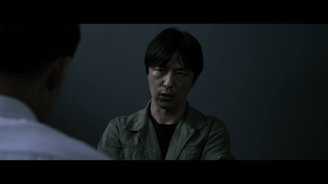 Man interrogating in dark room