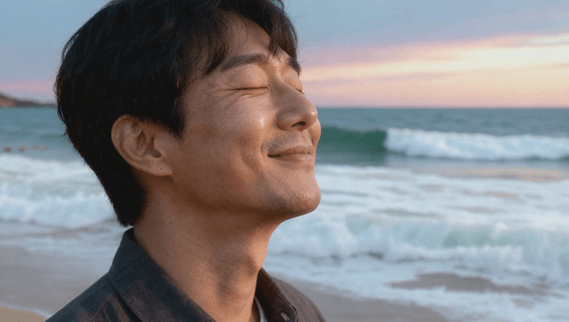 Man enjoying ocean at sunset on beach