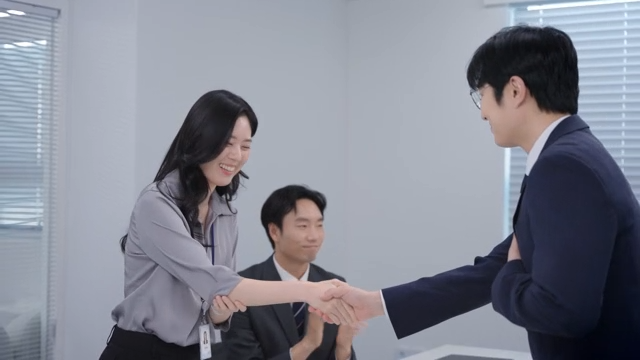 A meeting scene where the signed contract is handed over