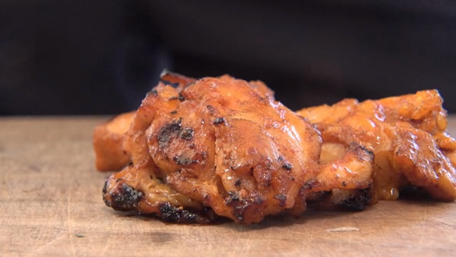 Spicy stir-fried chicken on a wooden board