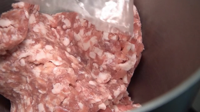 Ground meat being placed in a bowl