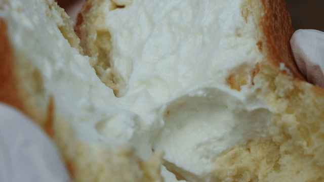 Cream-filled bread being torn open