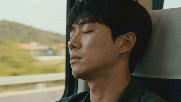 Man sleeping deeply on a train