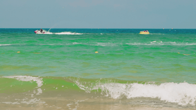 Jet ski towing tube at high speed on sea
