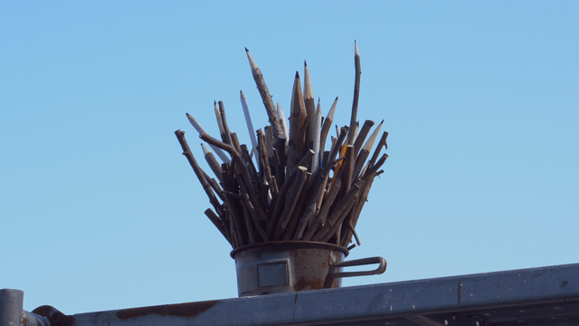 Wooden pencil sculpture under the clear sky