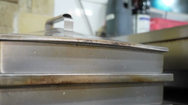 Steam rising from a large metal steamer