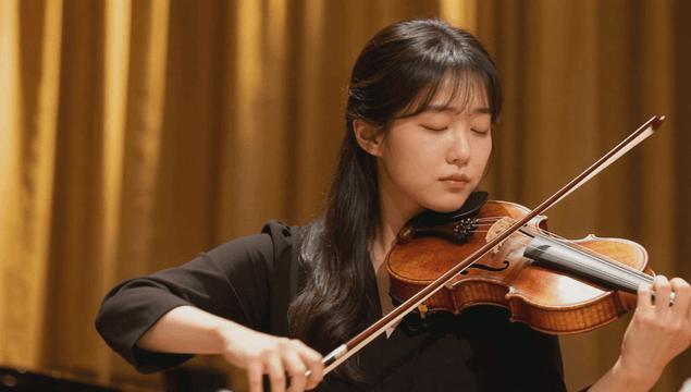 Woman playing the violin passionately