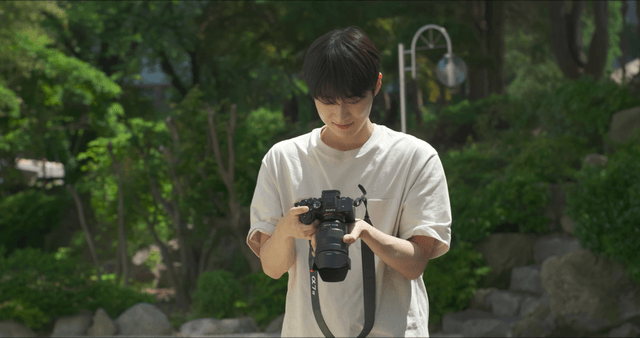 Person taking photos in a garden