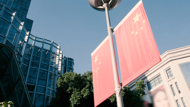 Chinese flag in front of a modern building