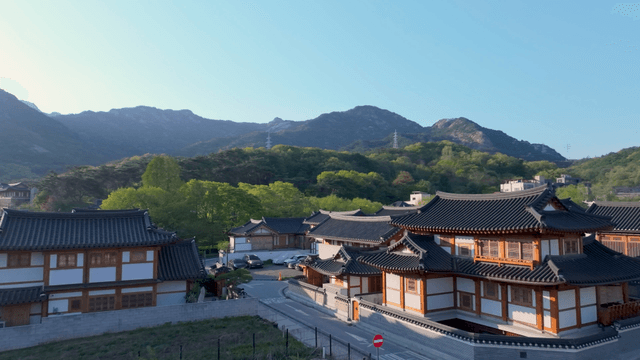Traditional hanok village with distant mountain view