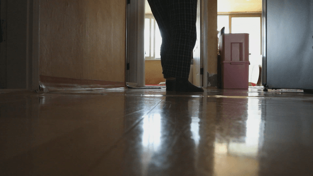 Elderly woman in home corridor