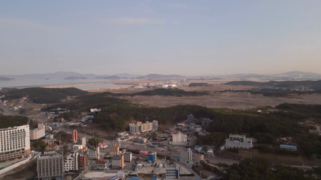 A coastal village with surrounding hills