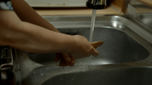 Washing dishes in a kitchen sink