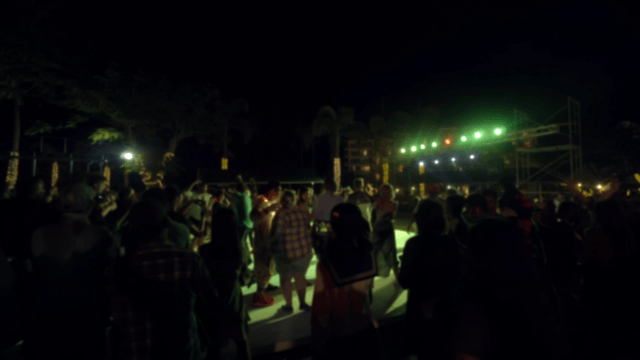 Nighttime outdoor party with a crowd