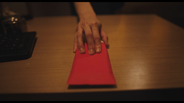 Woman handing red envelope