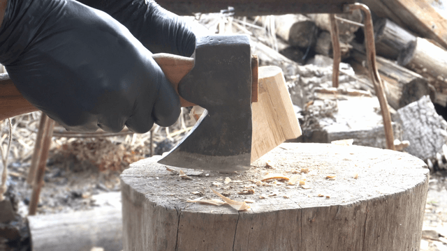 Chopping wood with an axe outdoors