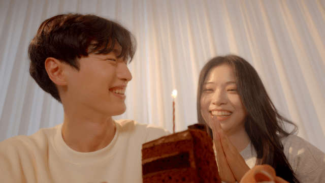 Couple celebrating with cake, clapping and singing