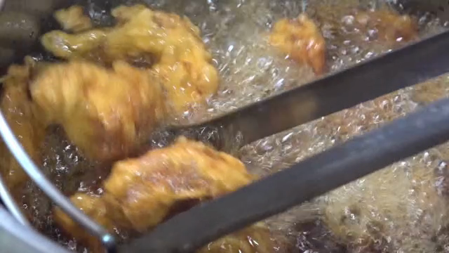 Frying chicken in hot oil