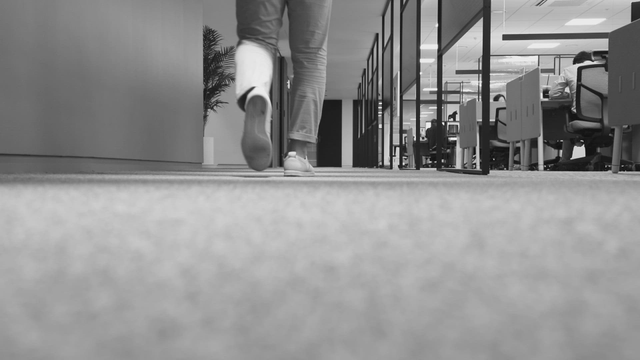 A person walking in an office hallway
