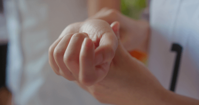 Friend caring about a student's wrist