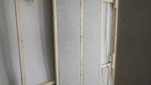 Wooden frame and insulation panel in a room