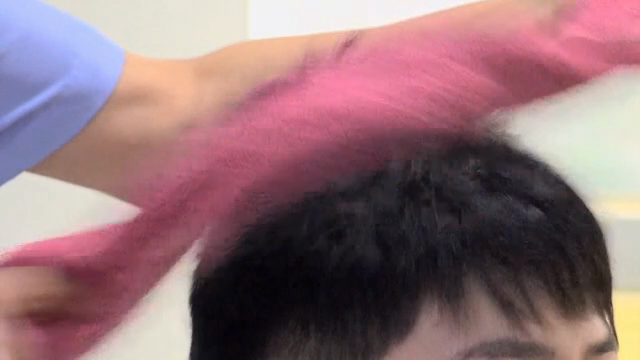 Hair being dried with a towel indoors