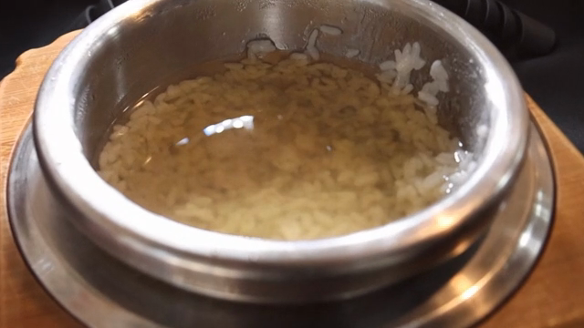 Scorched rice with water in a metal pot