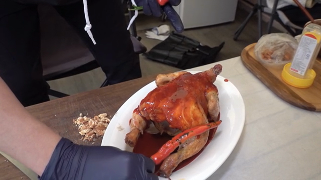 Chicken being prepared with sauce