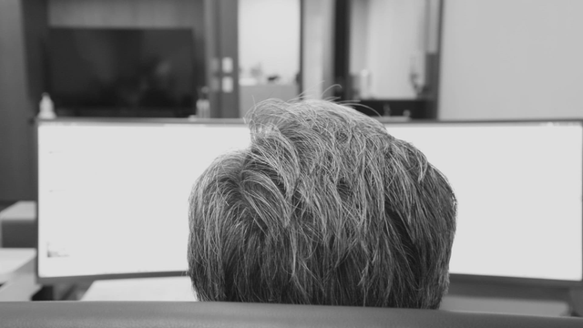 Person working at a desk with monitors