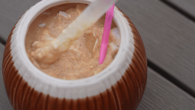 Cream drink served in a coconut shell cup