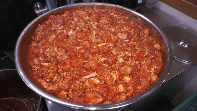 Large bowl filled with seasoned stir-fried chicken