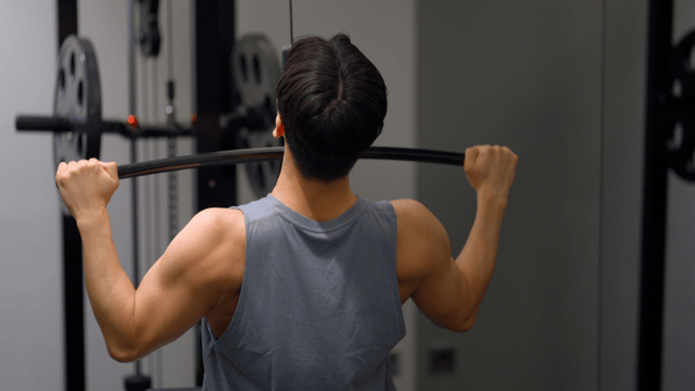 Man doing lat pulldown workout in gym