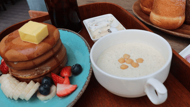 Pancakes with butter and syrup served with fruit