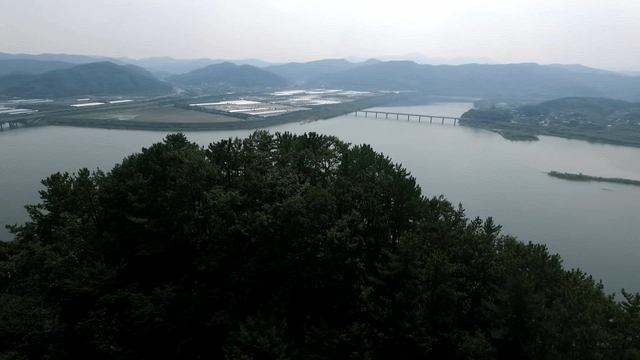 Mountain with a traditional pavilion and a wide river